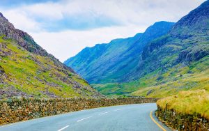 Landscape without Cars in empty road in Snowdonia of UK. Vacation trip on highway with nature.